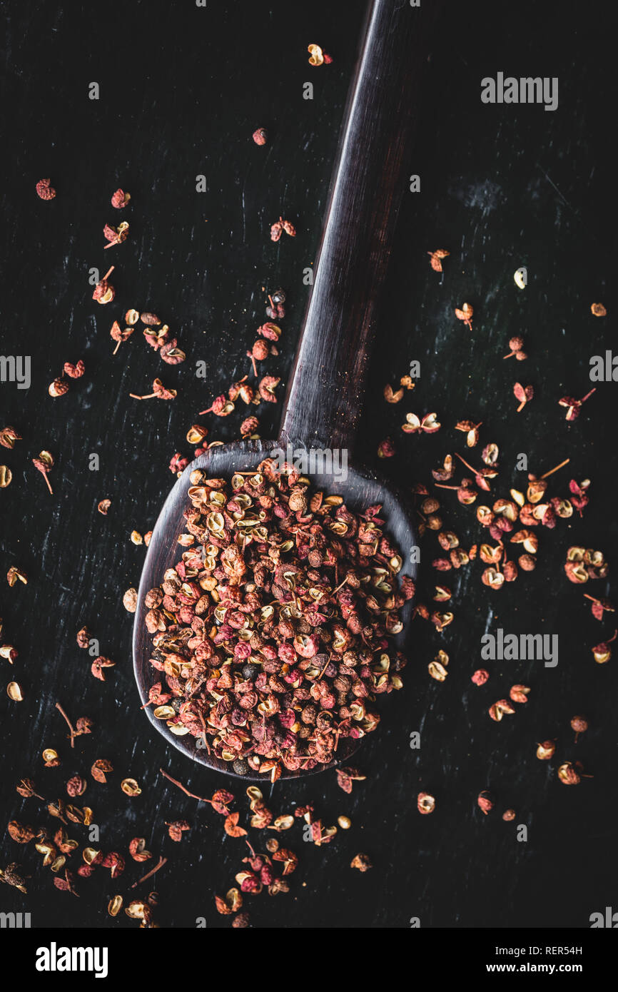 Directly above shot of Sichuan peppercorns on black background Stock Photo