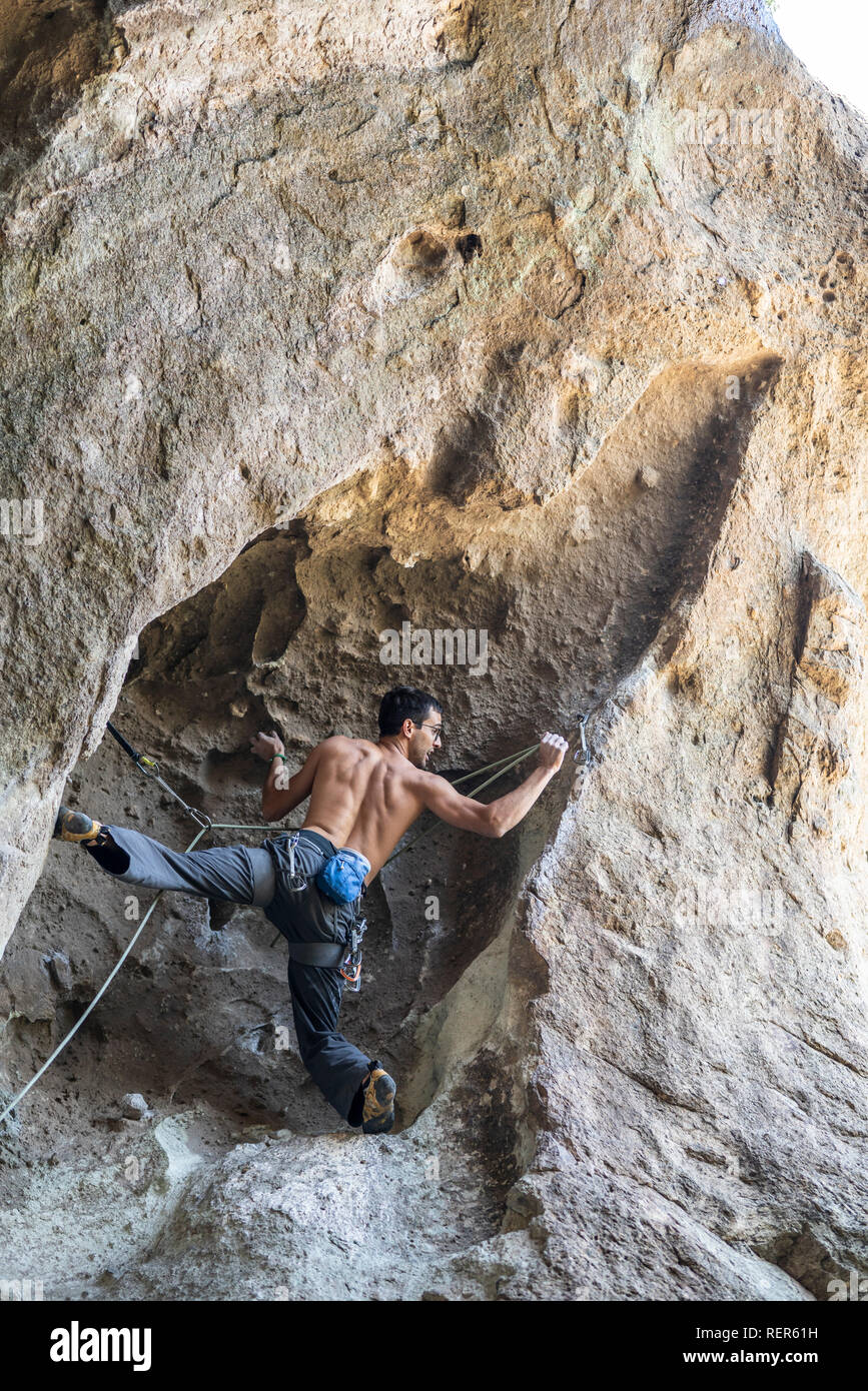Practicing rock climbing extreme sport inside Andes mountains at a rock
