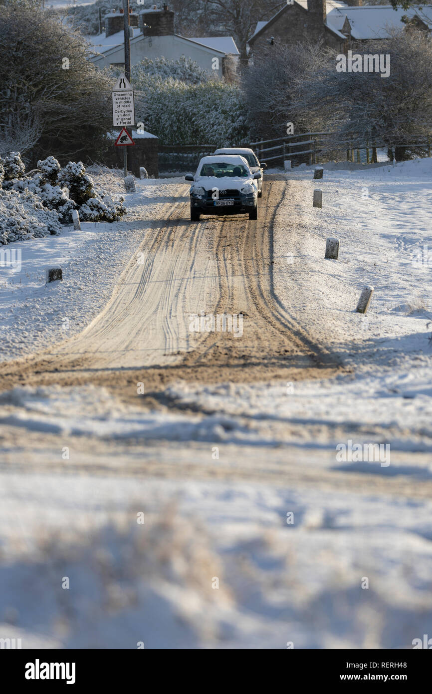 Flintshire, North Wales, UK. 23rd Jan, 2019. UK Weather: Heavy snowfall in North Wales with a Met Office Warning in place causing dangerous driving conditions and making it difficult to get out of rural villages in the area. Motorists attempting to leave the rural village of Moel-y-Crio with snow covered roads and frosty conditions, Flintshire Credit: DGDImages/Alamy Live News Stock Photo