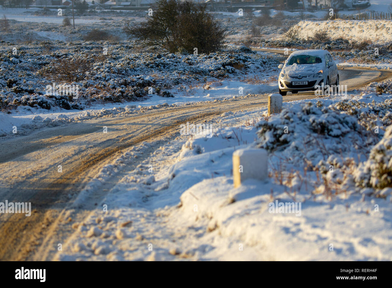 Flintshire, North Wales, UK. 23rd Jan, 2019. UK Weather: Heavy snowfall in North Wales with a Met Office Warning in place causing dangerous driving conditions and making it difficult to get out of rural villages in the area. A motorist travelling out of the Rhes-y-Cae village along a snow covered rural lane after heavy overnight snow, Flintshire, Wales Credit: DGDImages/Alamy Live News Stock Photo