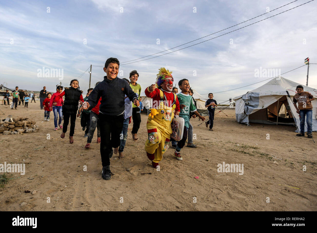 Gaza, Palestine. Autonomous Areas. 02nd Apr, 2018. The Palestinian clown Alaa Mekdad (34) plays with refugee children in the tent city built on the occasion of the protest action 'March of Return' at the border to Israel in the Gaza Strip. The photograph by dpa photographer Mohammed Talatene won 1st place in the Story category in the dpa Picture of the Year 2018 competition. Credit: Mohammed Talatene/dpa/Alamy Live News Stock Photo