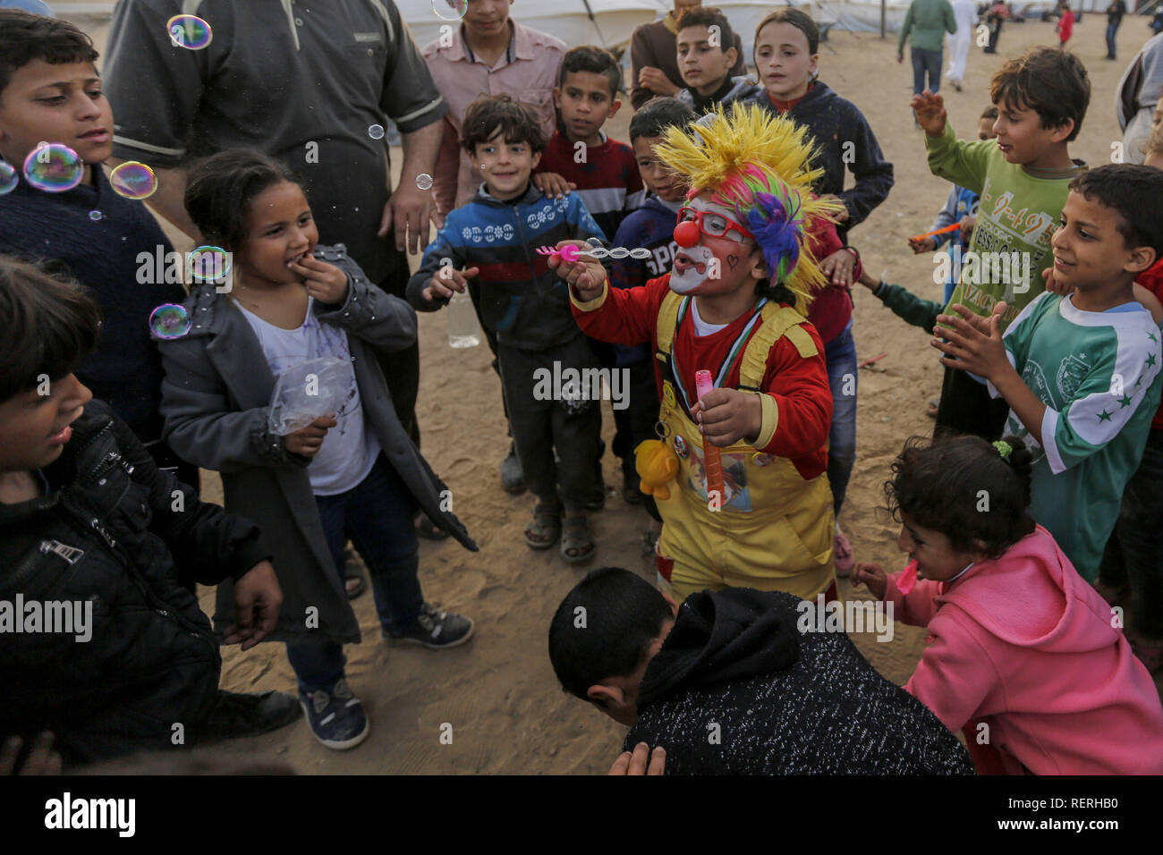 Gaza, Palestine. Autonomous Areas. 02nd Apr, 2018. The Palestinian clown Alaa Mekdad (34) plays with refugee children in the tent city built on the occasion of the protest action 'March of Return' at the border to Israel in the Gaza Strip. The photograph by dpa photographer Mohammed Talatene won 1st place in the Story category in the dpa Picture of the Year 2018 competition. Credit: Mohammed Talatene/dpa/Alamy Live News Stock Photo
