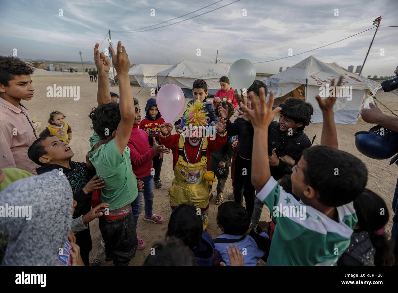 Gaza, Palestine. Autonomous Areas. 02nd Apr, 2018. The Palestinian clown Alaa Mekdad (34) plays with refugee children in the tent city built on the occasion of the protest action 'March of Return' at the border to Israel in the Gaza Strip. The photograph by dpa photographer Mohammed Talatene won 1st place in the Story category in the dpa Picture of the Year 2018 competition. Credit: Mohammed Talatene/dpa/Alamy Live News Stock Photo