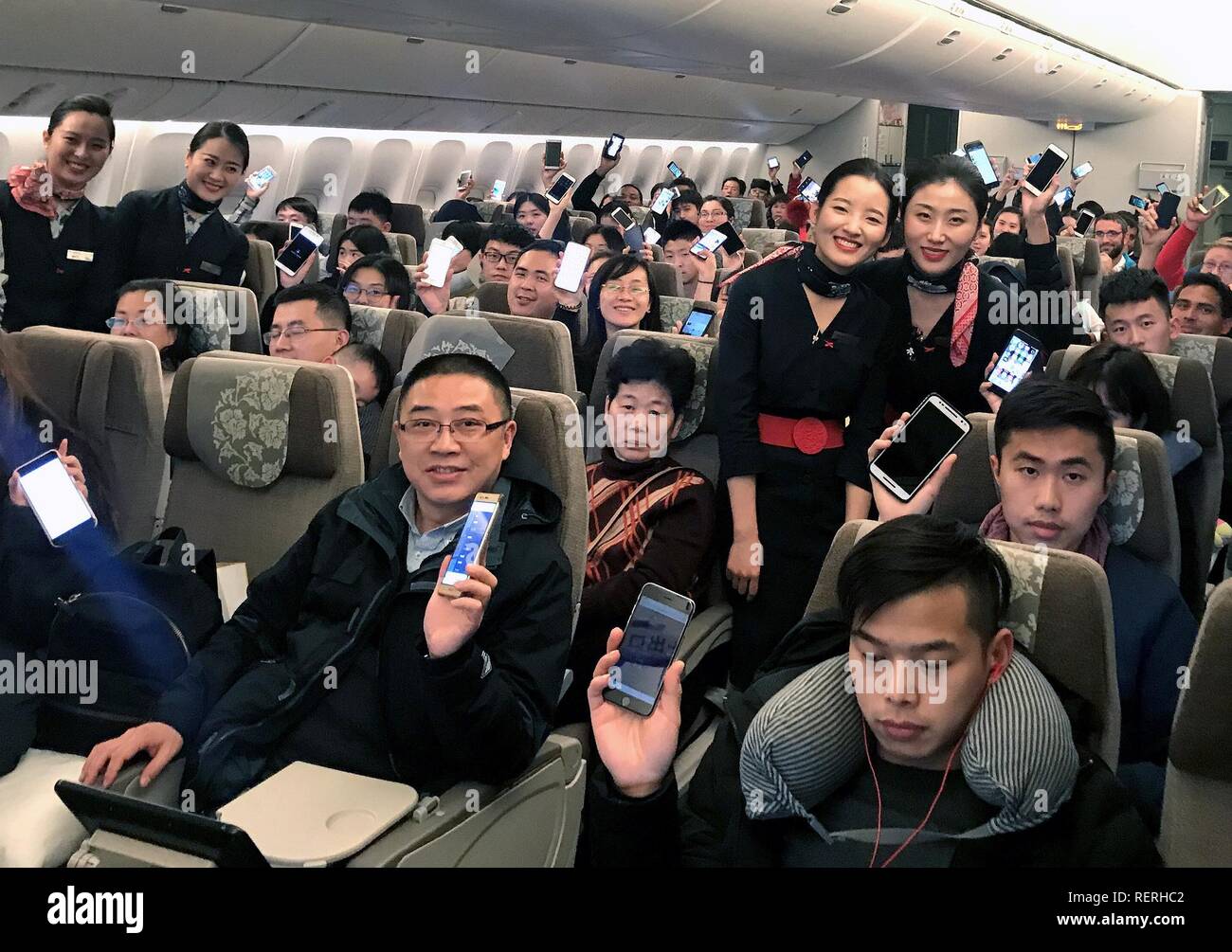 (190123) -- BEIJING, Jan. 23, 2019 (Xinhua) -- Passengers show their mobile phones accessing aviation internet on Flight MU553 of China Eastern Airlines Jan. 18, 2018. China's civil aviation industry is accelerating its advance into the digital era, with major players sending clear signals of new opportunities worldwide. (Xinhua) Stock Photo