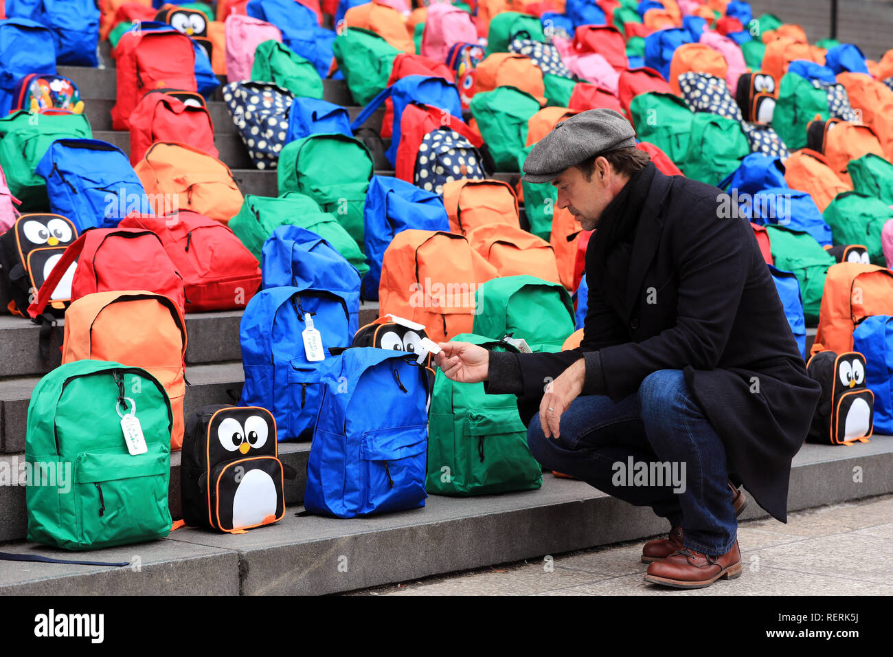 London, UK. 23rd January, 2018. Actor and WaterAid Ambassador Dougray Scott looks at the 800 schoolbags laid by WaterAid on the steps of St Paul’s Cathedral in a moving tribute to the number of children who die every day from dirty water, never reaching their fifth birthday or first day at school. WaterAid placed 800 children’s schoolbags on the famous steps of St Paul’s Cathedral today as a stark reminder of the number of young children’s lives lost every single day due to dirty water and poor sanitation.   Credit: Oliver Dixon/Alamy Live News Stock Photo