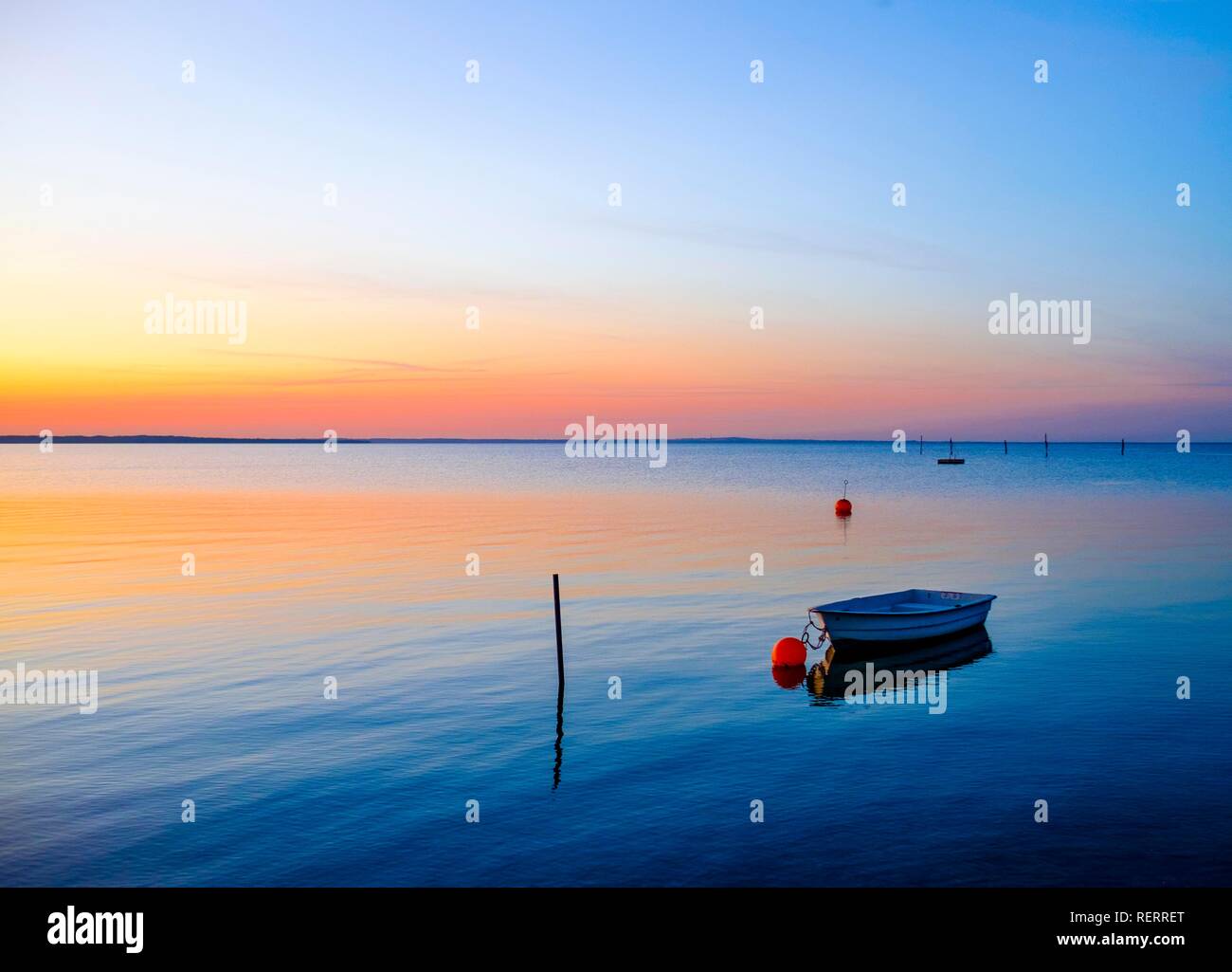 Rowing boat lies in the sea in the evening, Middelfart, Funen, Denmark Stock Photo