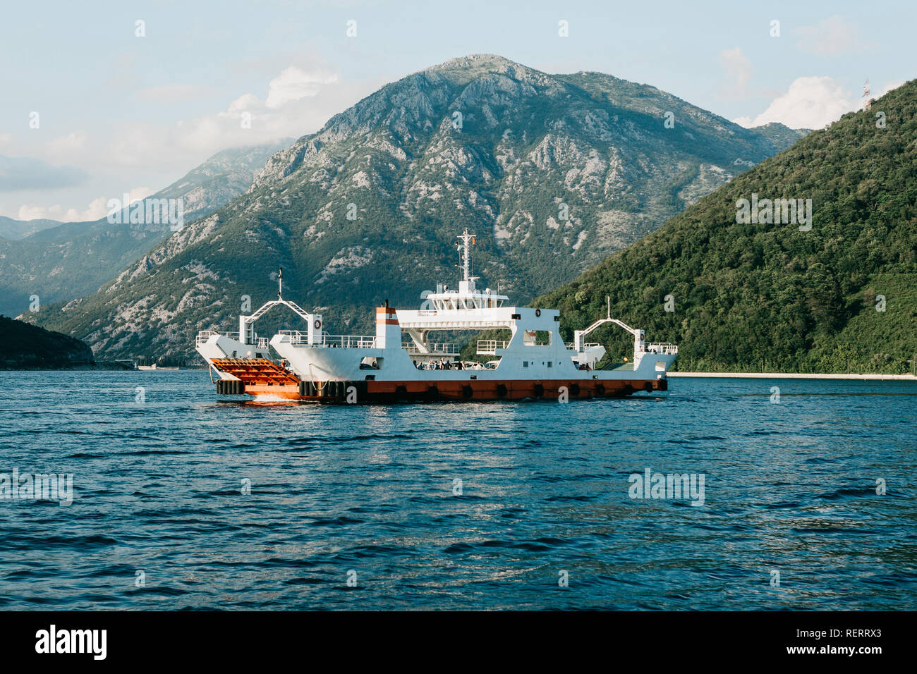 Ferry to transport vehicles and people crosses the bay in Montenegro. Stock Photo