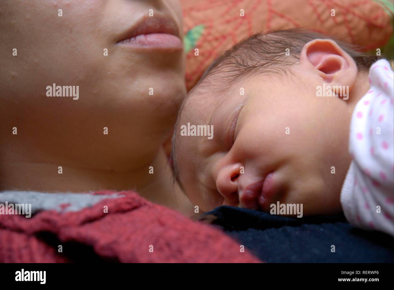 A newborn baby sleeping on her mother's chest Stock Photo Alamy