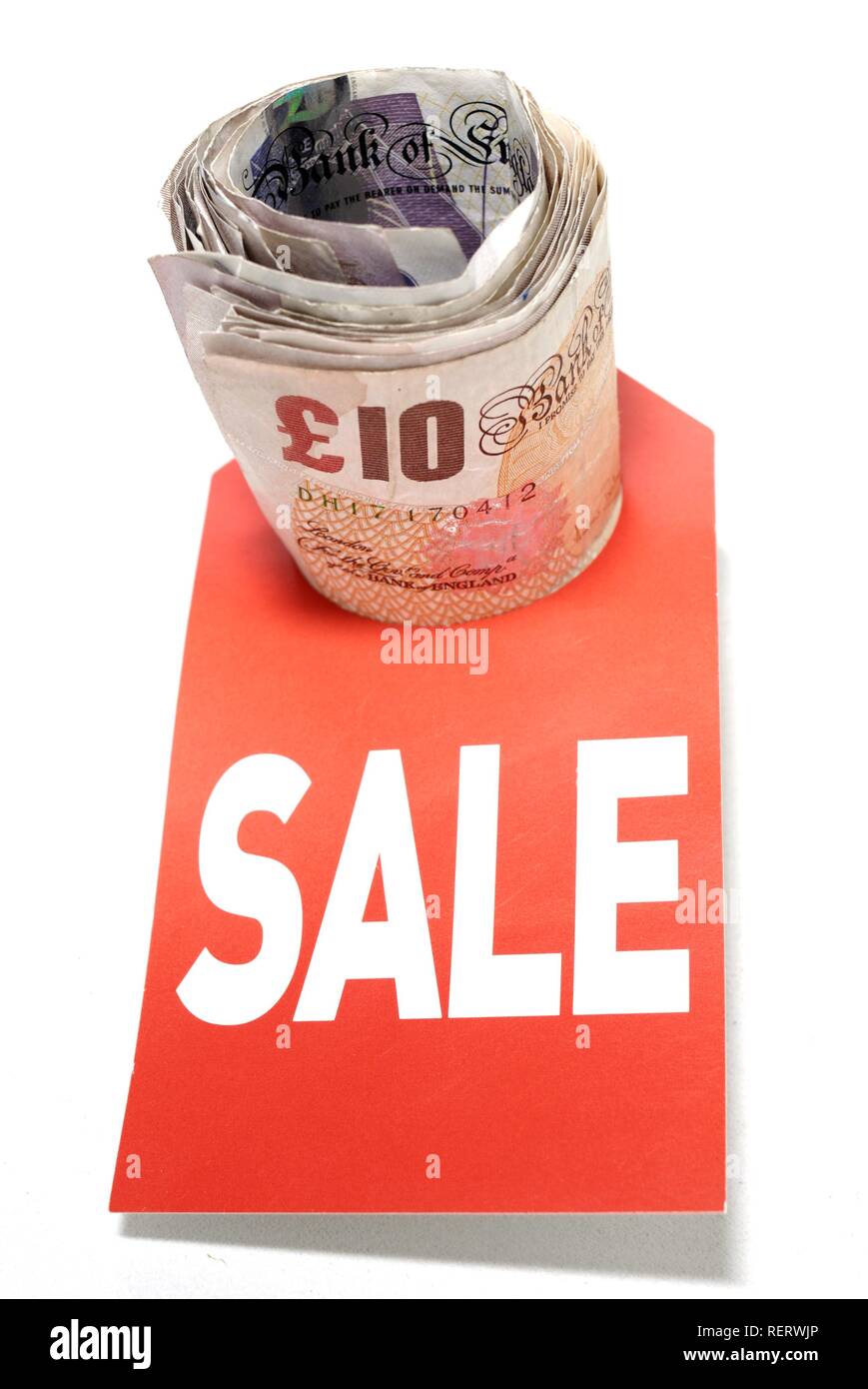 Money, lettering 'Sale', conceptual photograph illustrating falling interest rates, cheap credit and currency value Stock Photo