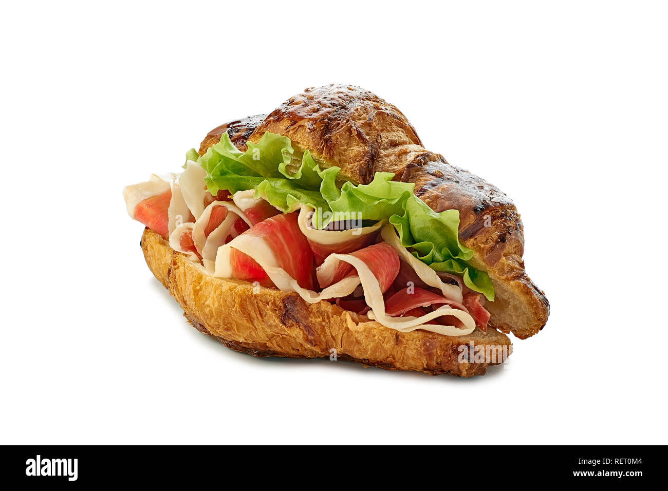 Croissant sandwich with jamon of ham and lettuce on white Stock Photo