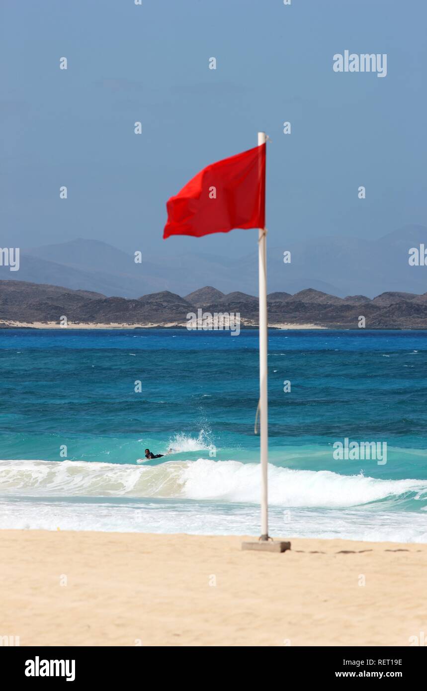 Red flag on a beach to indicate that swimming is forbidden, Playa de los Matos, near Corralejo in the north of the island of Stock Photo
