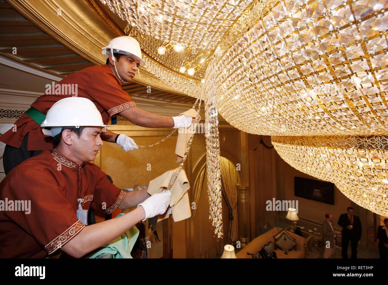 Emirates Palace Hotel, Kempinski Group, staff cleaning one of more than 150 crystal chandeliers