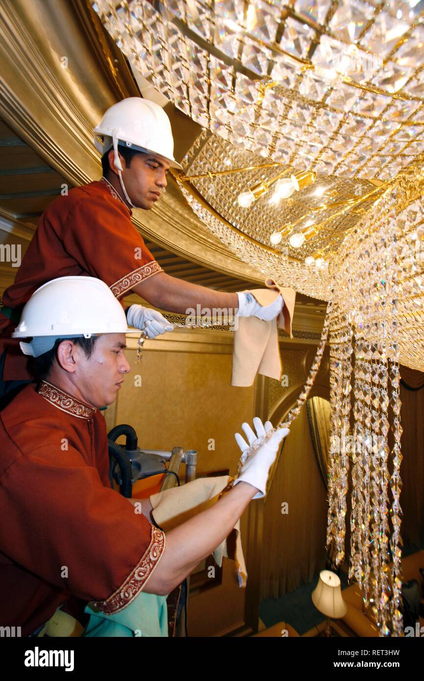 Emirates Palace Hotel, Kempinski Group, staff cleaning one of more than 150 crystal chandeliers