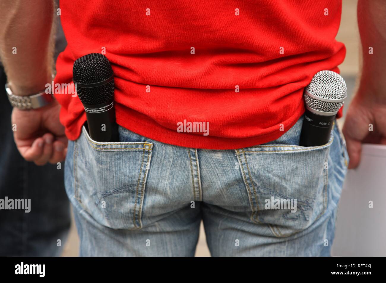 Man with 2 wireless microphones in the rear pockets of his jeans, moderator at an event, Germany Stock Photo
