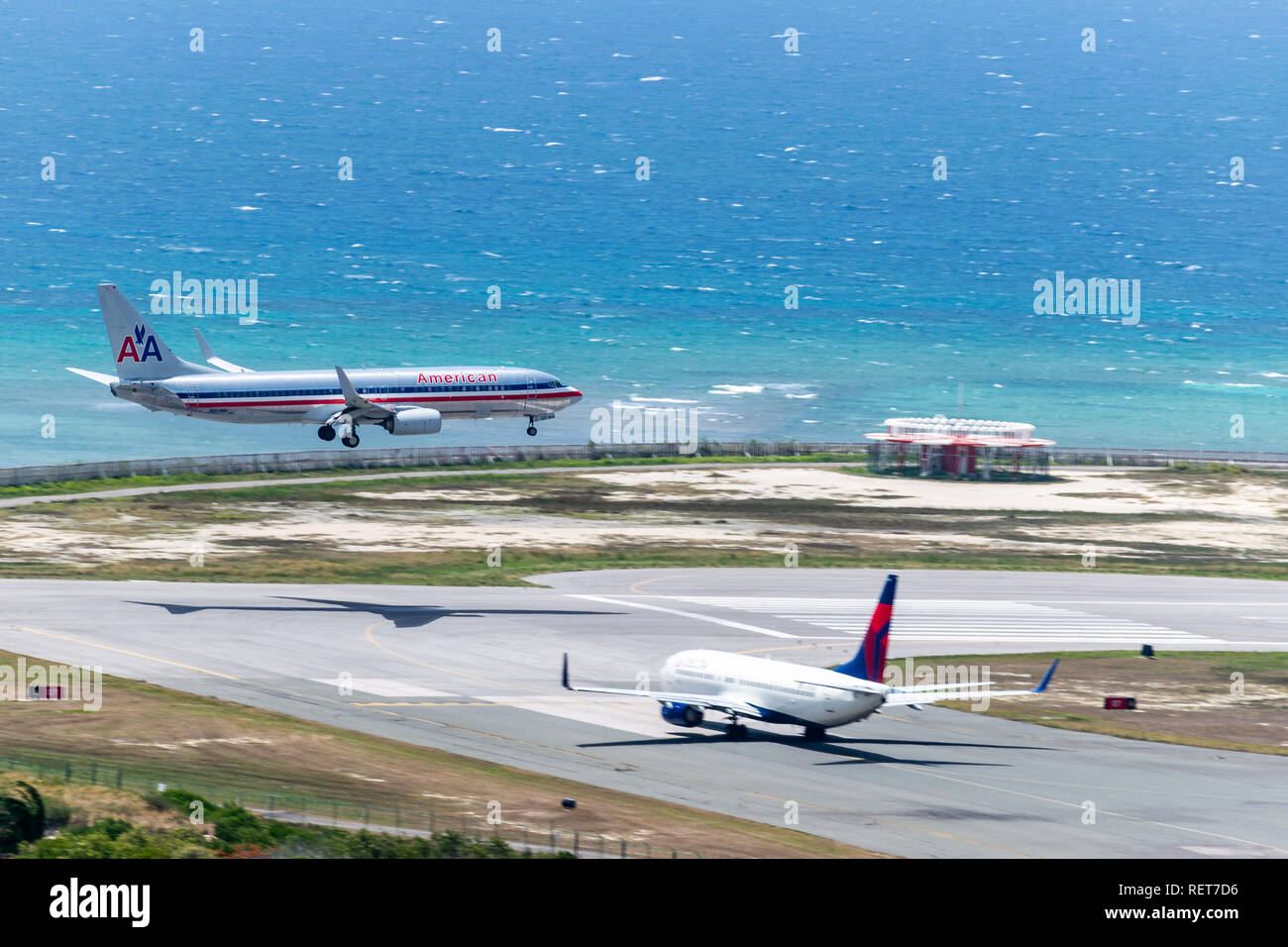 Montego Bay, Jamaica - July 03 2015: American Airlines aircraft landing while Delta waits to depart from the Sangster International Airport (MBJ) Stock Photo