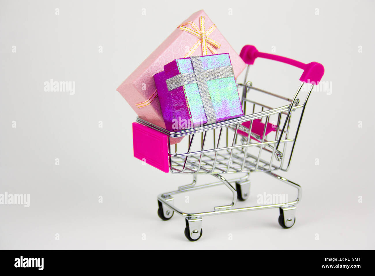 shopping cart with gift boxes on light background Stock Photo