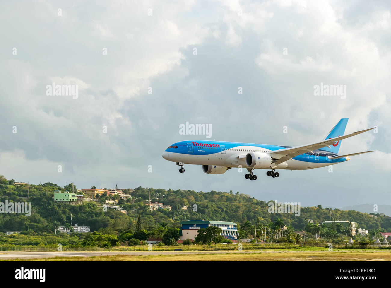 Montego Bay, Jamaica - February 18 2015: Thomson Airways (TUI) boeing aircraft landing at the Sangster International Airport in Montego Bay, Jamaica Stock Photo