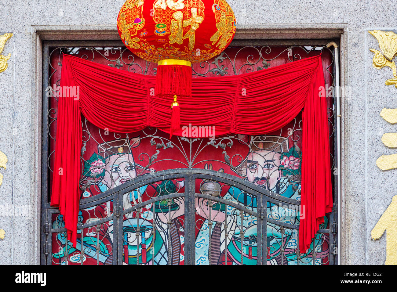 lanterns hanging on painted doors in The Toishan Nin Yong Temple for Chinese New Year in Georgetown, Penang, Malaysia Stock Photo