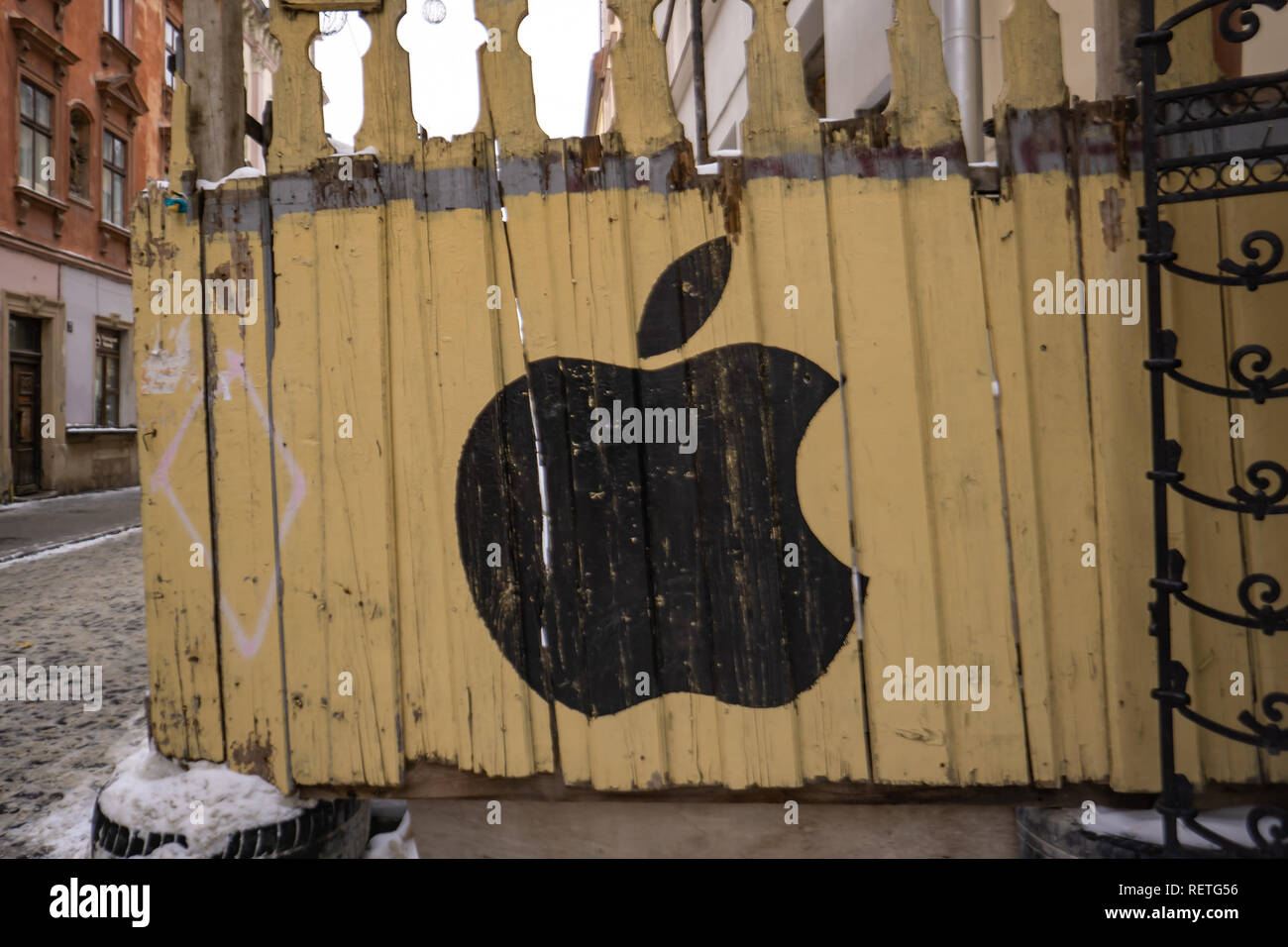 Logo Apple, painted on the old fence. 01.13.2019 Lviv. Ukraine Stock Photo