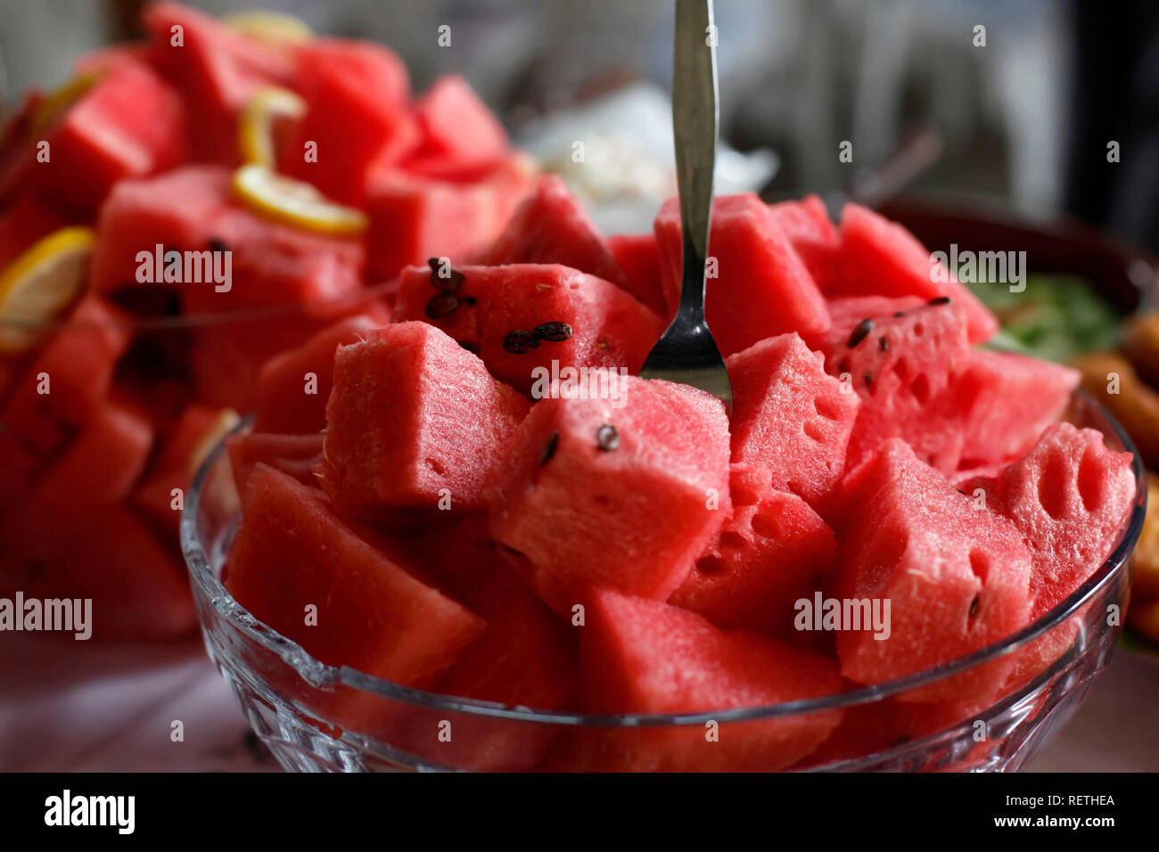 Large Glass Bowl Filled With Watermelon Cubes And Fork Stuck In The Middle Stock Photo Alamy