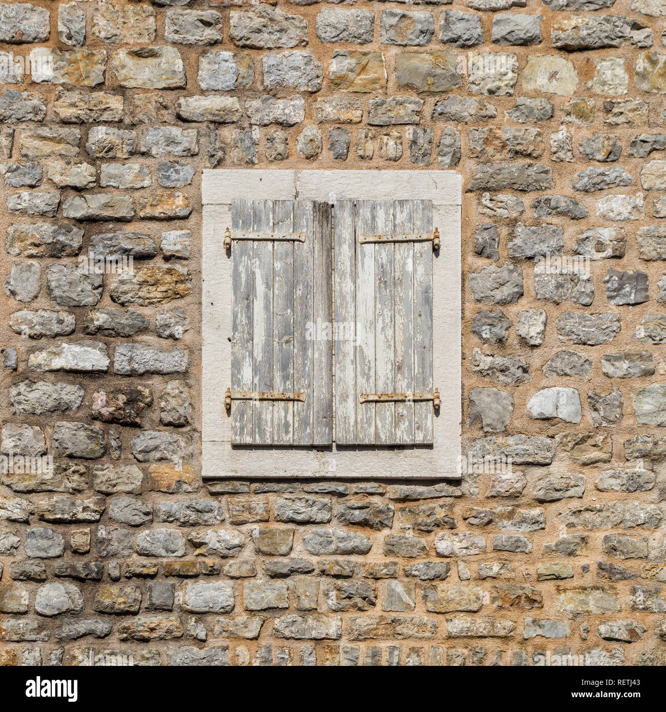 Old window closed with wooden shutters in the stone wall Stock Photo ...