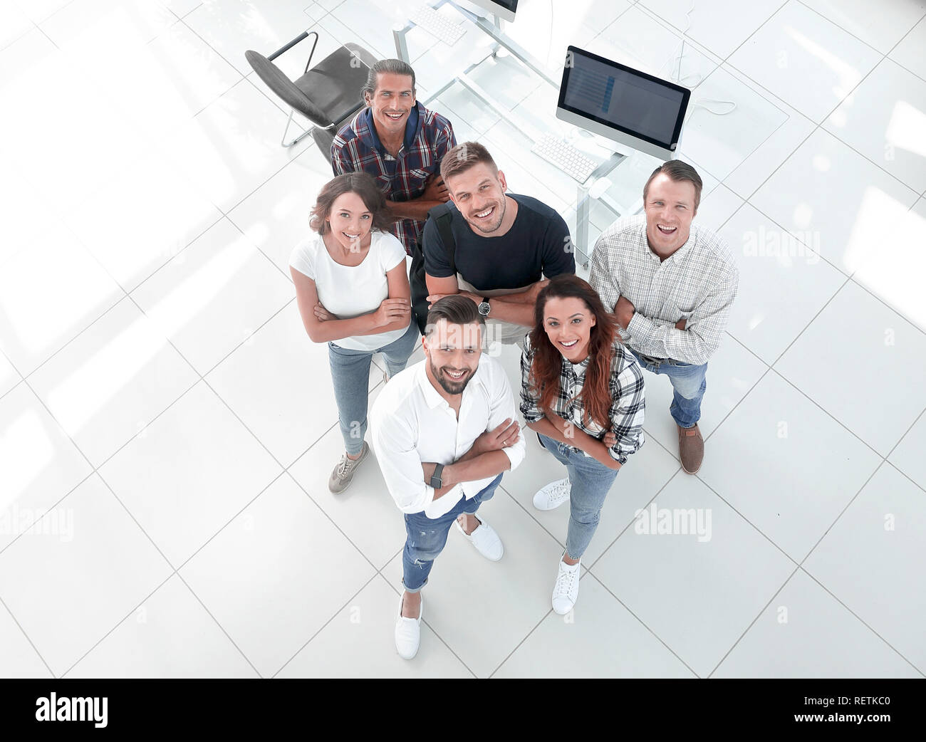 young professionals standing near the desktop Stock Photo - Alamy