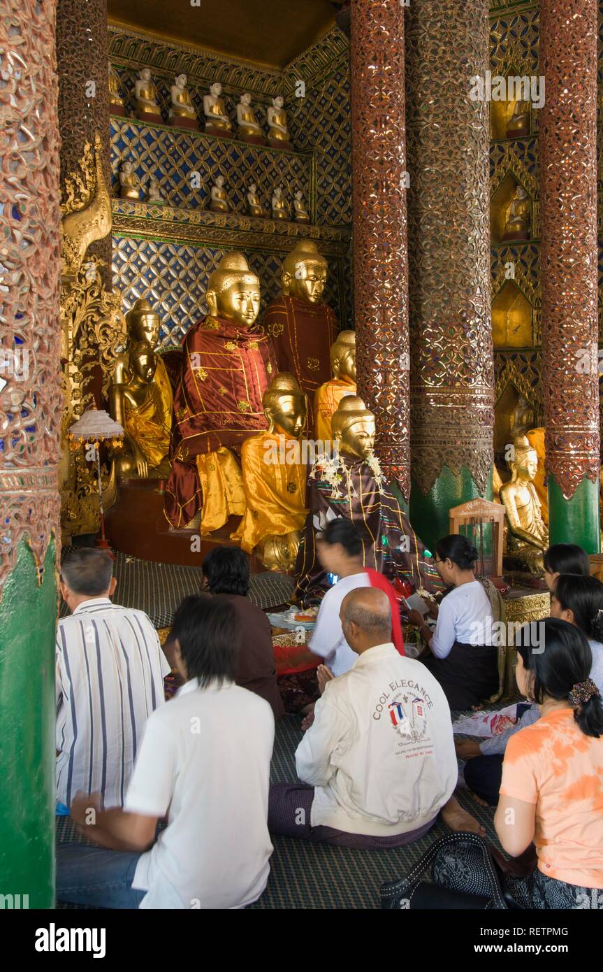 Praying Devotees, Gotama Buddha Temple, Shwedagon Pagoda, Yangon, Myanmar, Burma, Southeast Asia Stock Photo