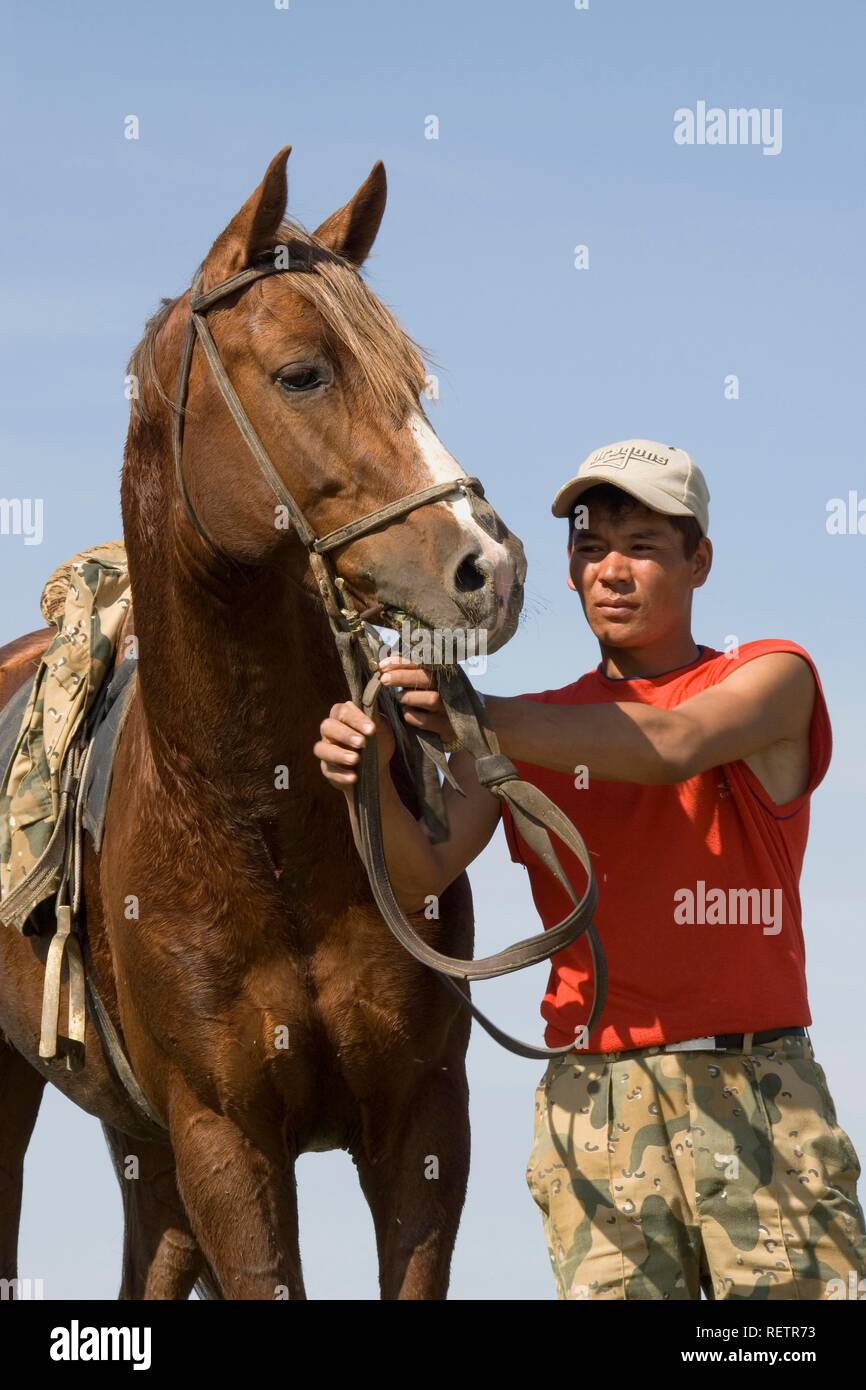 Kazakh man with his horse, Kazakhstan Stock Photo
