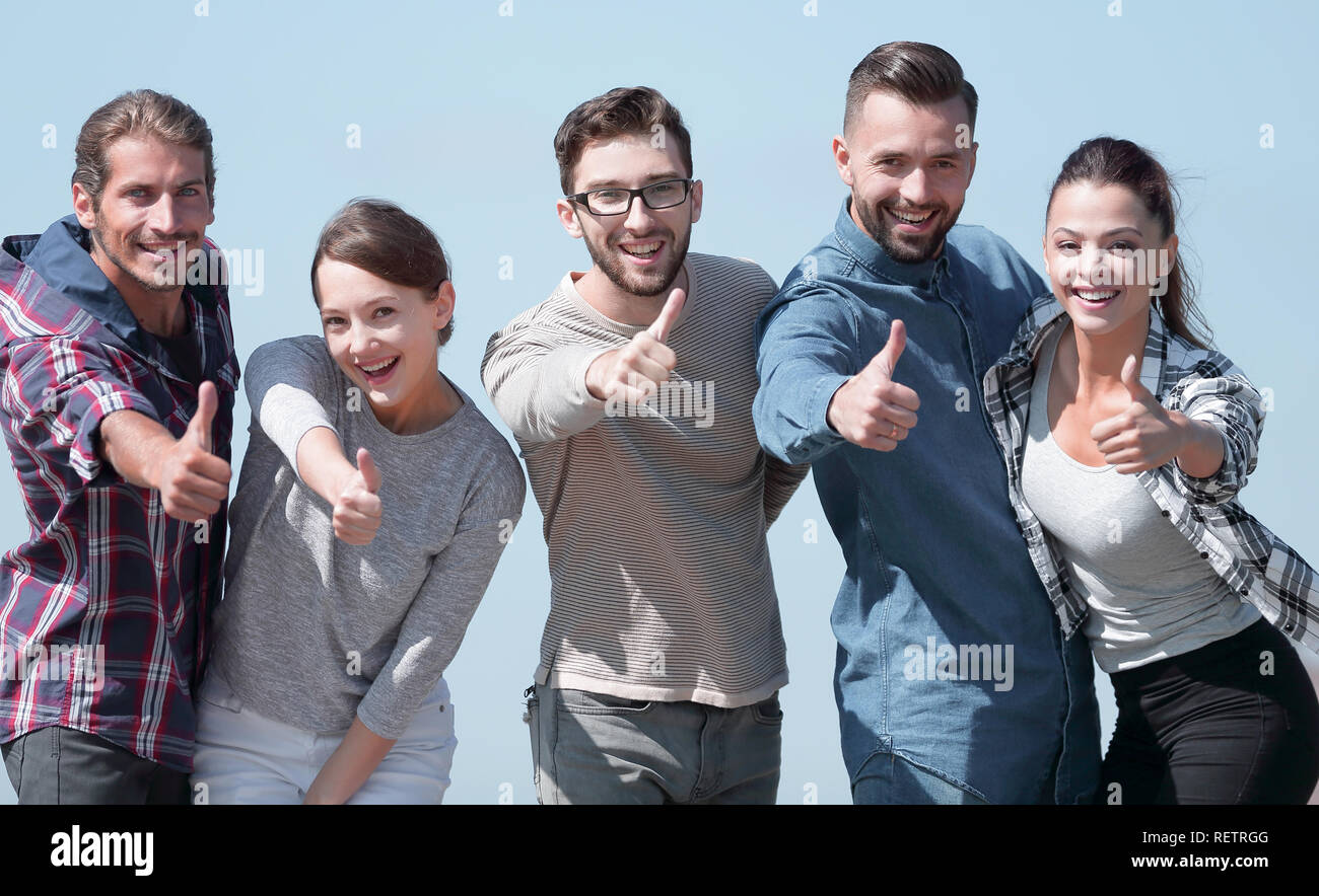 smiling group of young people showing thumb up Stock Photo - Alamy