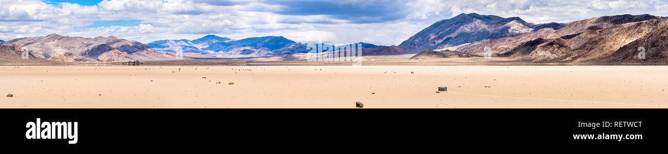 Panoramic view of the Racetrack Playa surrounded by steep mountains on a cloudy day, Death Valley National Park, California Stock Photo