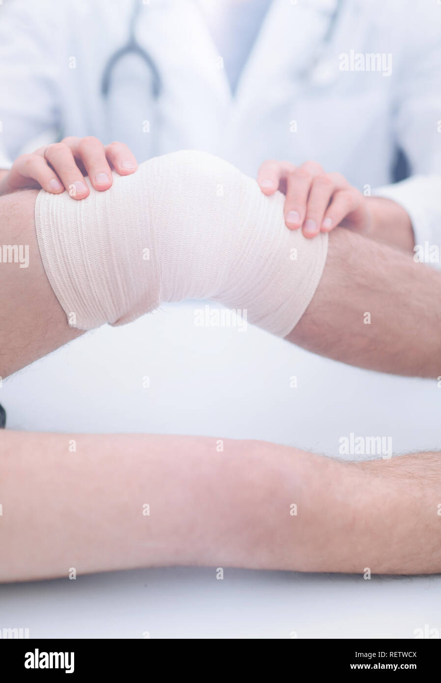 traumatologist ,applying a bandage on the knee Stock Photo Alamy