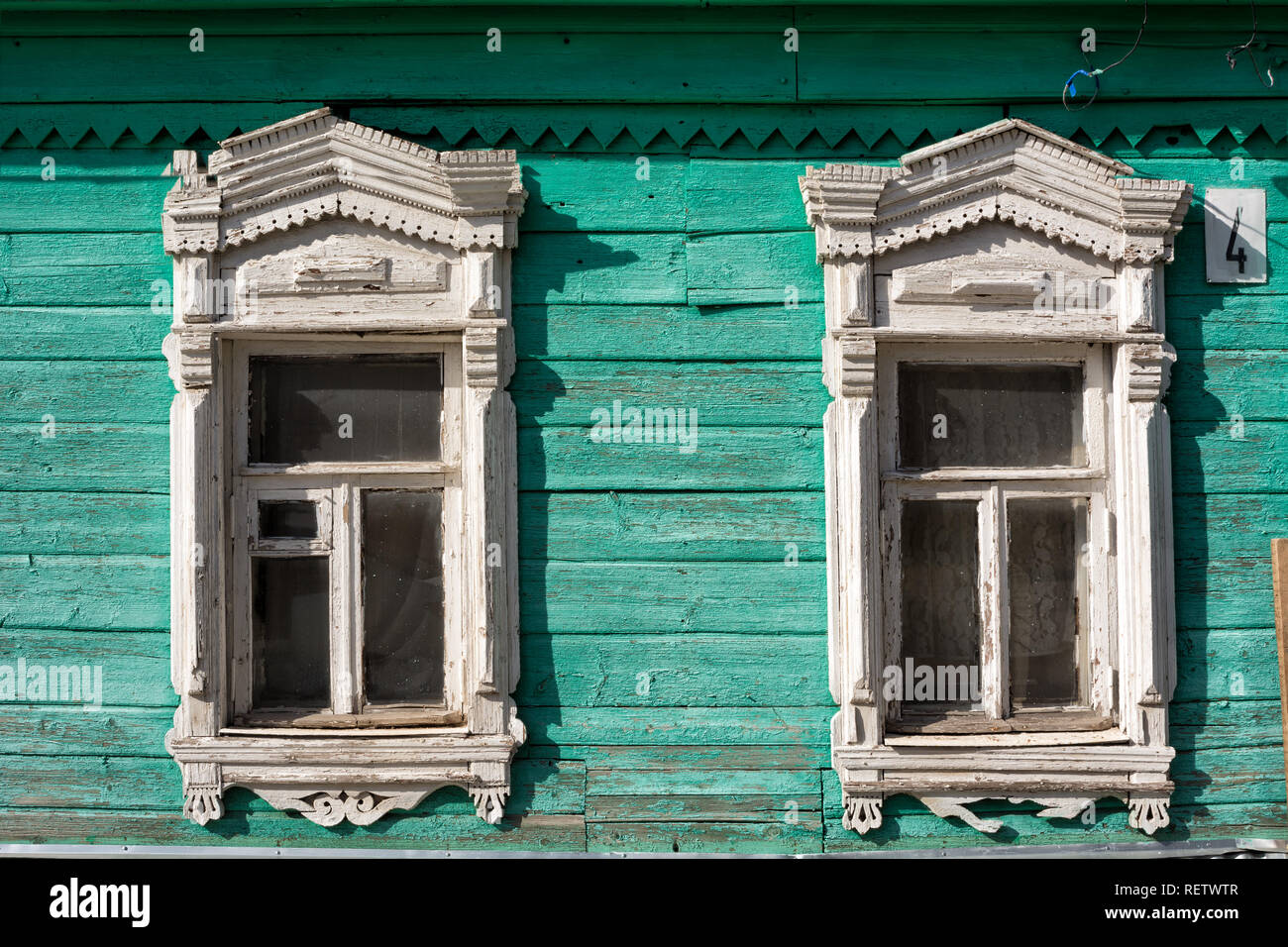 Painted facade of a wooden house with decorative wood carving in the old town of Kolomna in Russia. Stock Photo