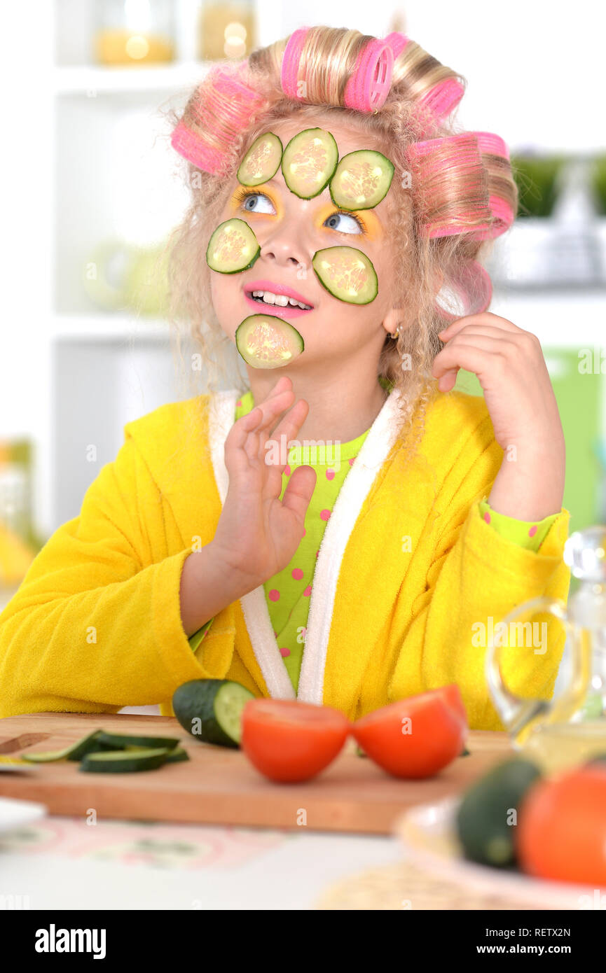 Happy cute little girl with hair curlers Stock Photo