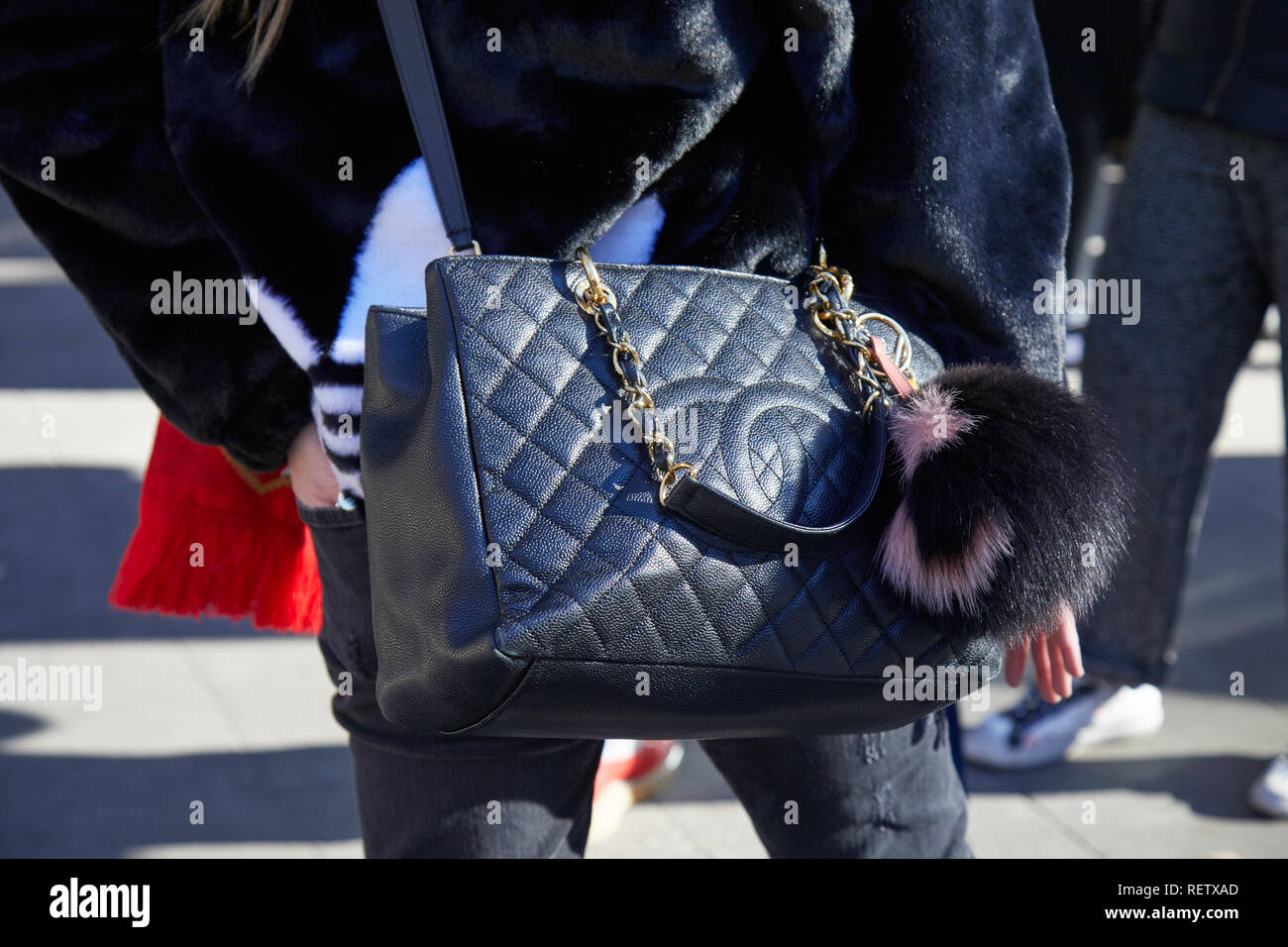 MILAN, ITALY - JANUARY 14, 2019: Woman with black Chanel leather bag with  fur keyring before Emporio Armani fashion show, Milan Fashion Week street  st Stock Photo - Alamy