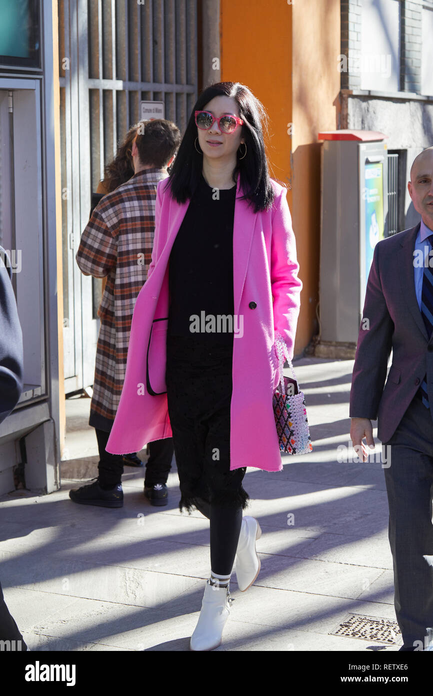 MILAN, ITALY - JANUARY 14, 2019: Woman with pink coat and black