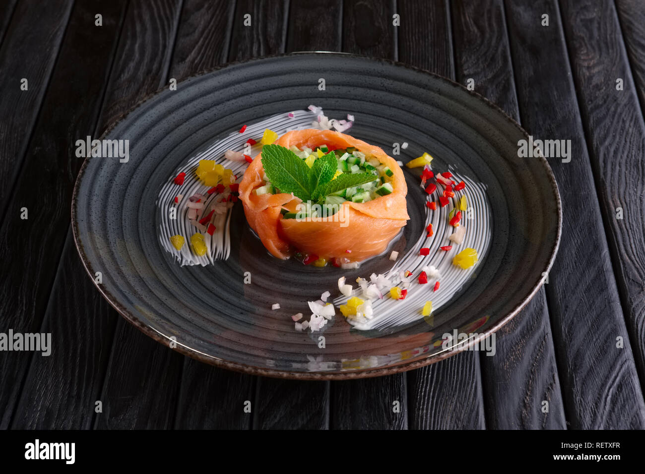 Smoked salmon stripes with cucumber, bell and chili pepper and onion Stock Photo
