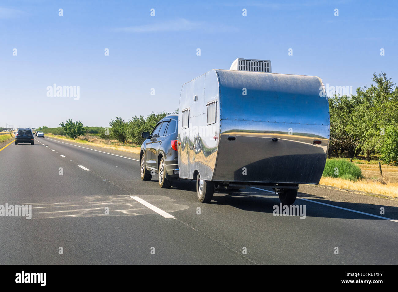 Car towing a trailer on the interstate, California Stock Photo - Alamy