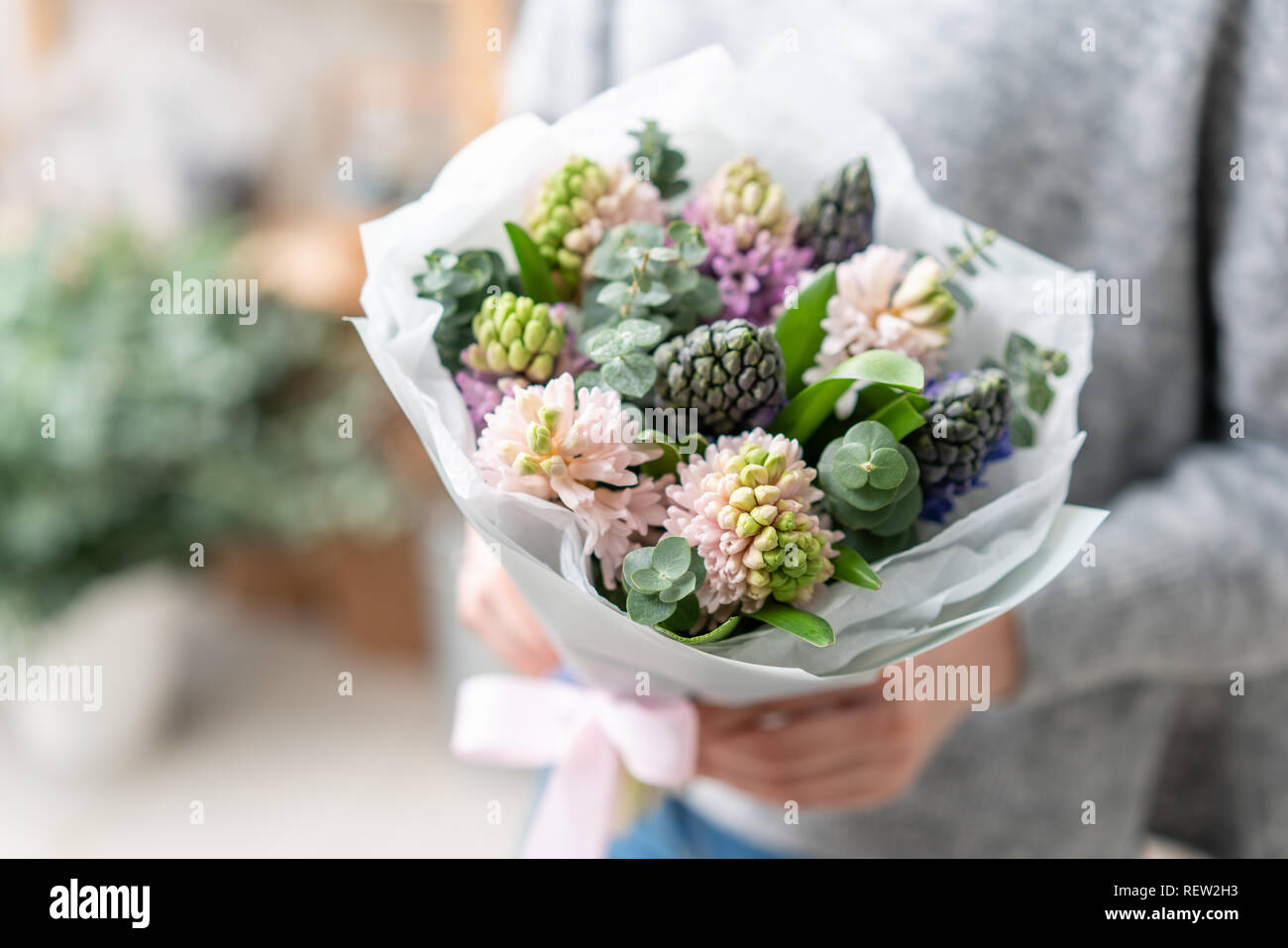 beautiful fresh cut bouquet of mixed flowers in woman hand. the work of