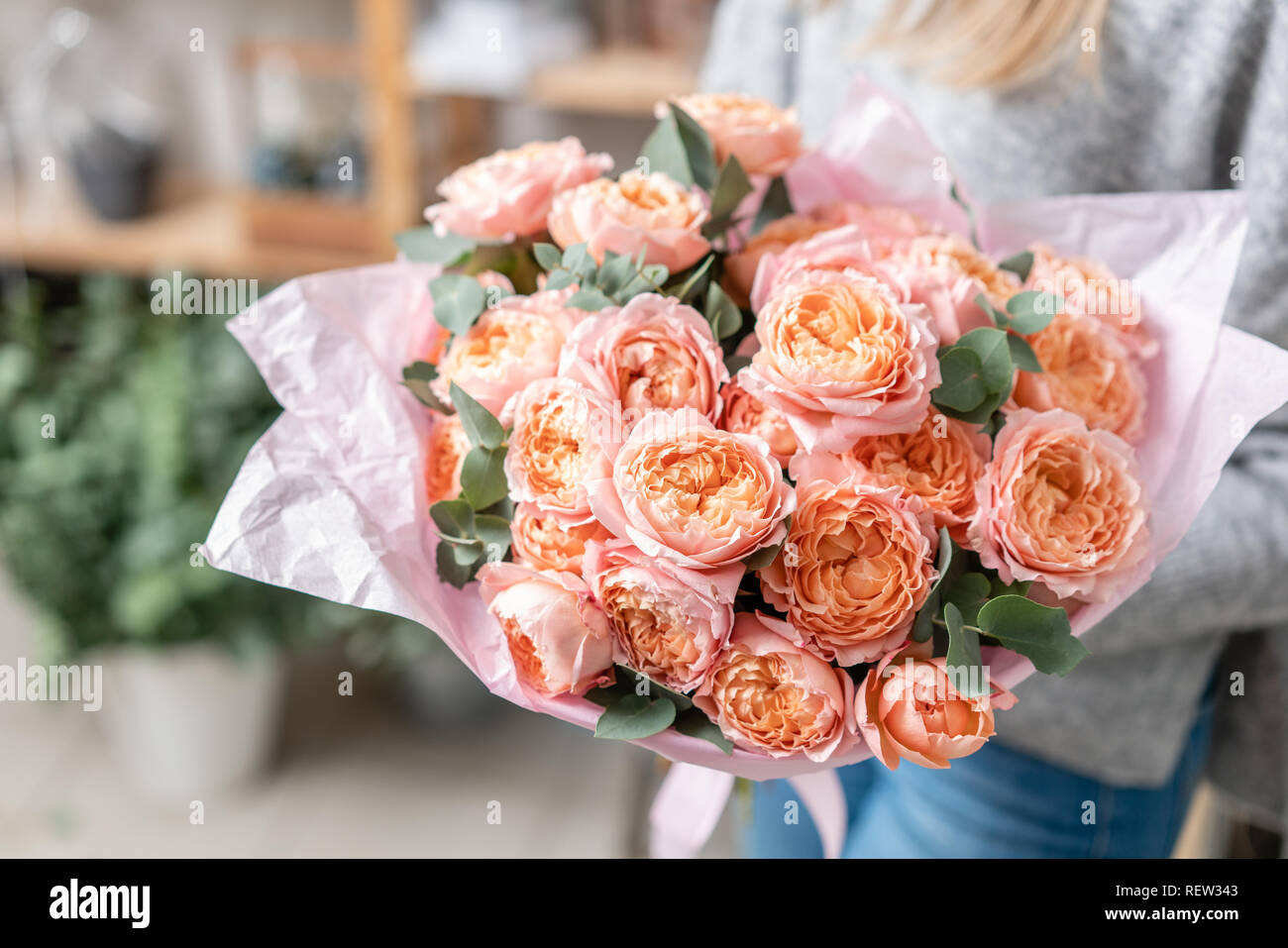 beautiful fresh cut bouquet of mixed flowers in woman hand. the work of