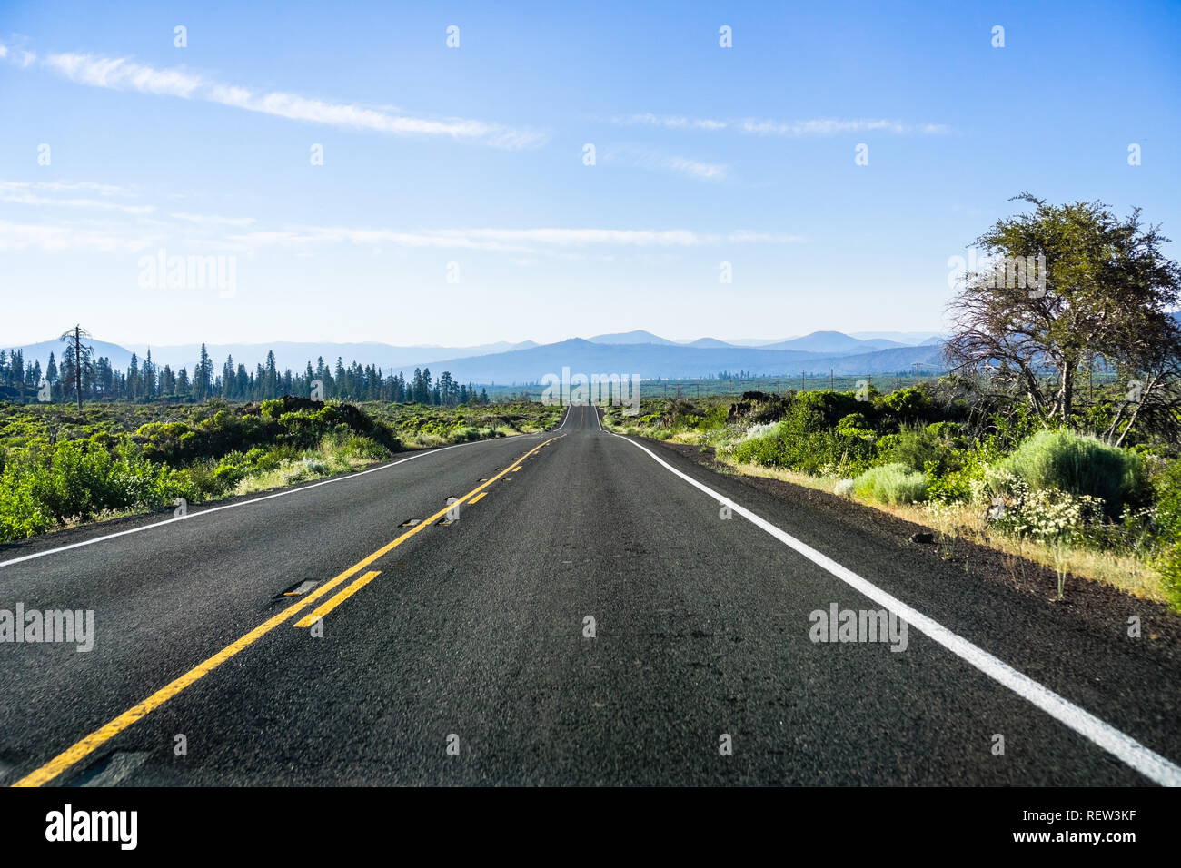 Driving on a straight, empty road in Shasta County, Northern California Stock Photo