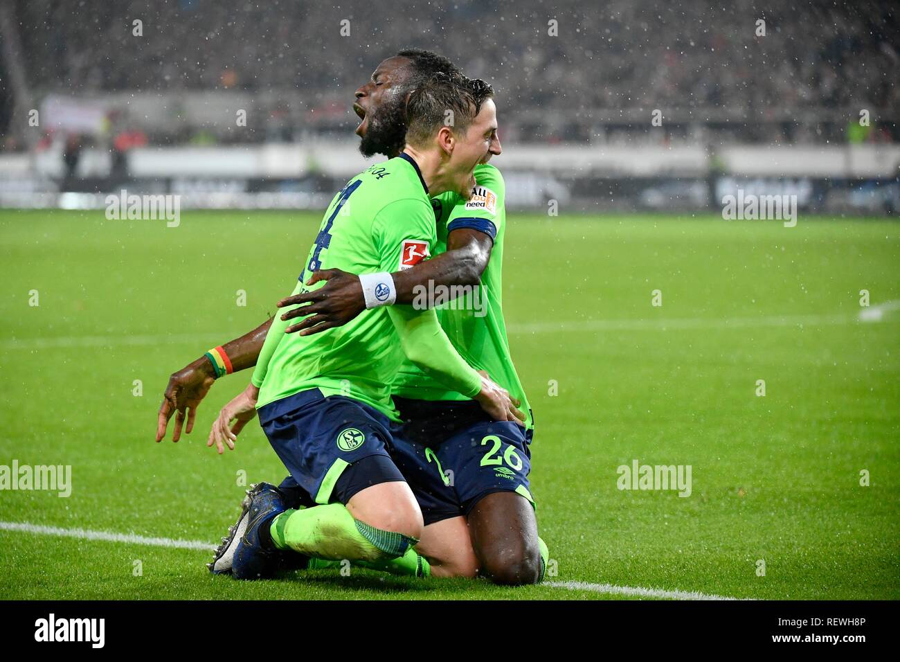 Goal celebration in the rain, Salif Sané, FC Schalke 04 with Bastian Oczipka FC Schalke 04, Mercedes-Benz Arena, Stuttgart Stock Photo