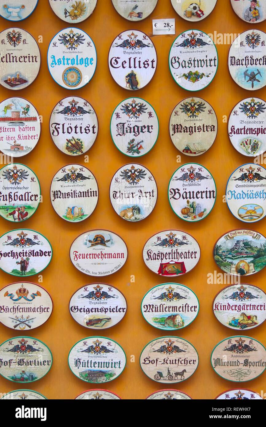 Small colourfully painted wooden signs of various professions, Salzburg, Austria Stock Photo