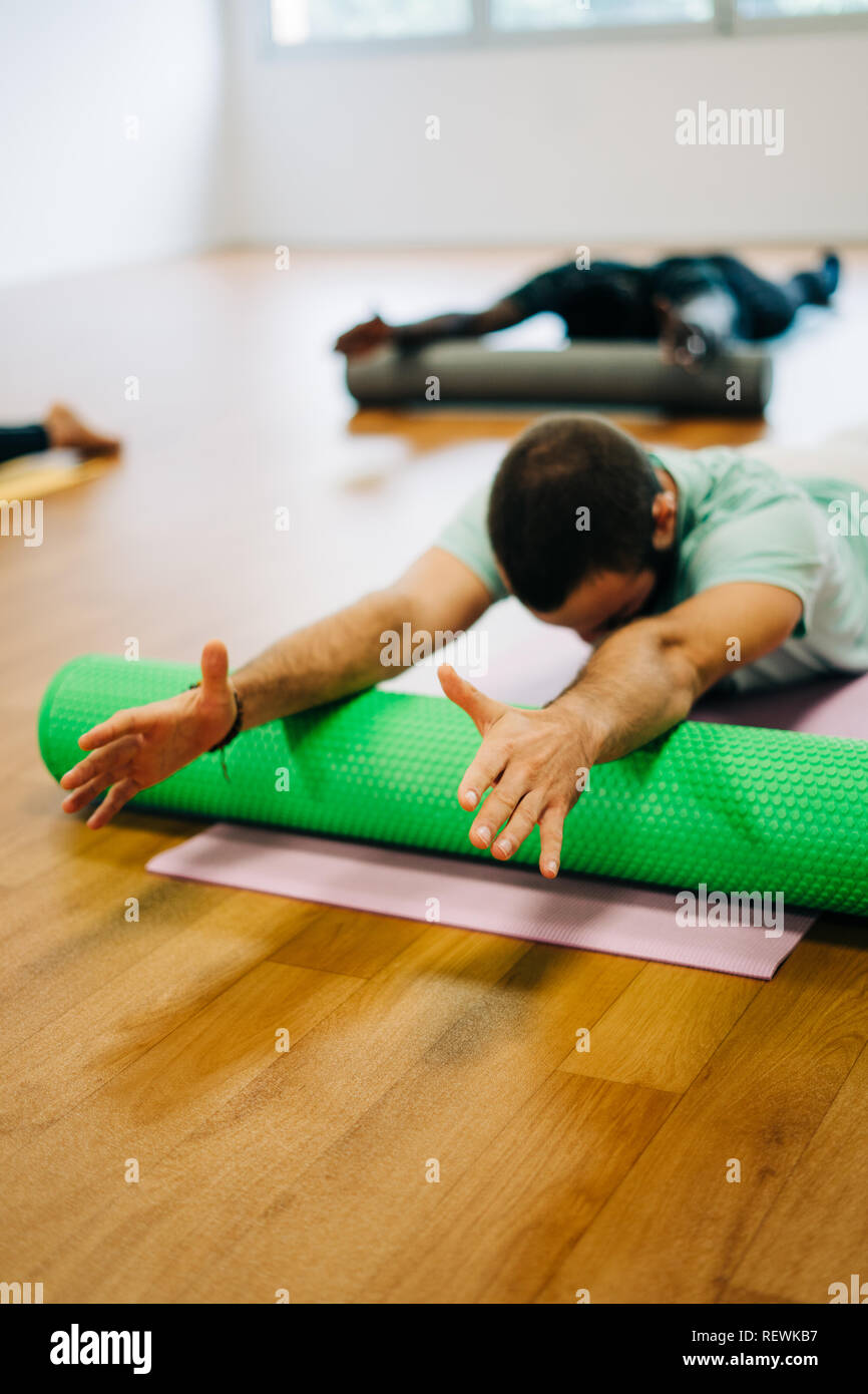 People doing exercises with foam rollers in the gym Stock Photo - Alamy
