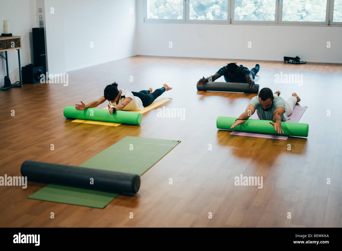 People doing exercises with foam rollers in the gym Stock Photo Alamy