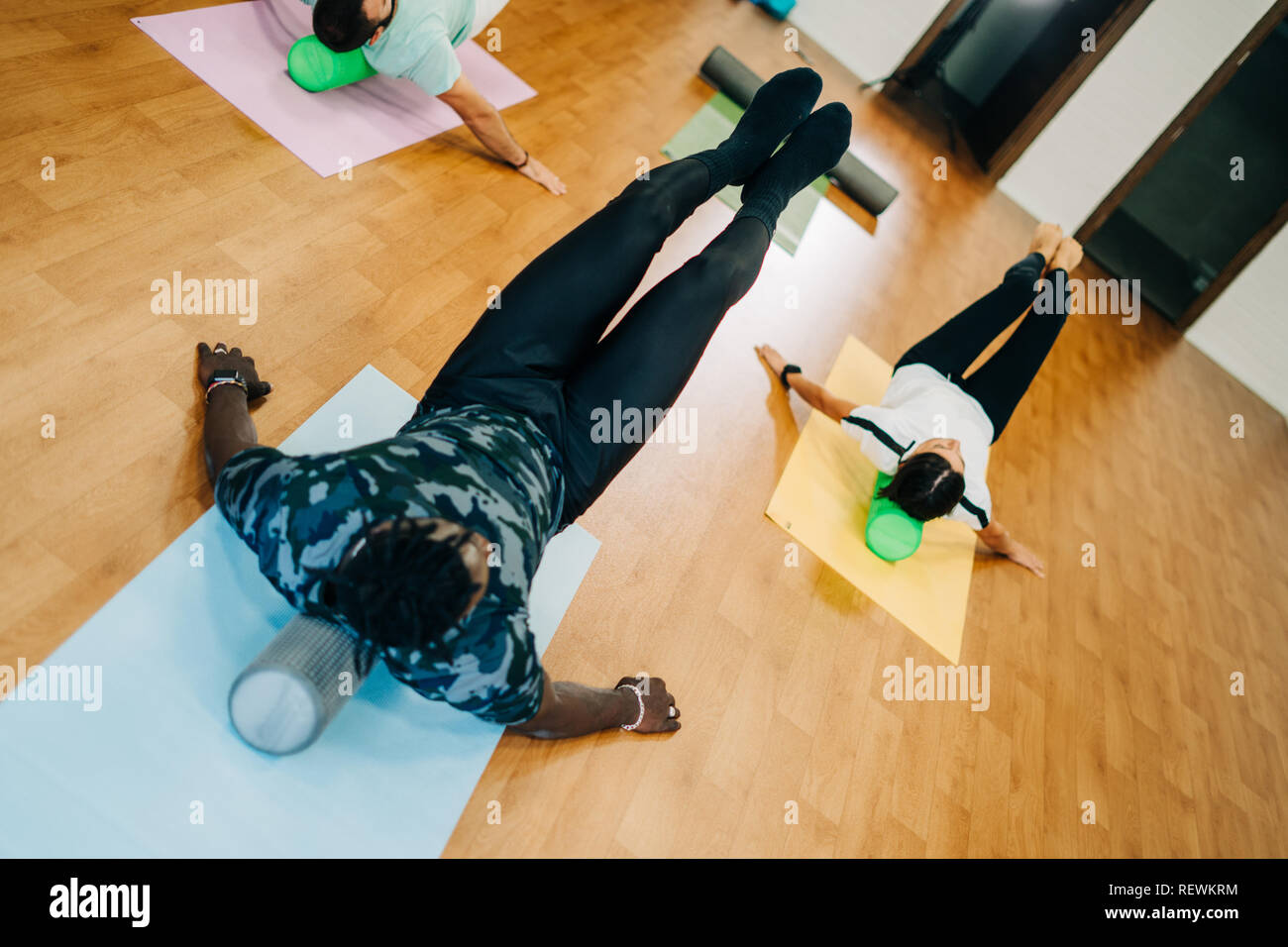 People doing exercises with foam rollers in the gym Stock Photo Alamy