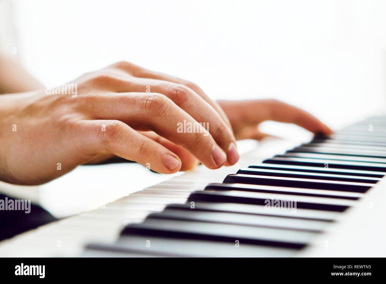 Close up of pianists hands playing piano. Shallow deep of field. Stock Photo