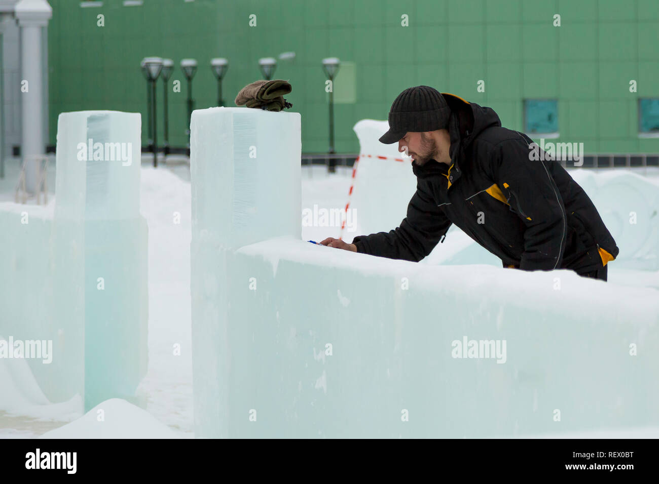 The artist draws the contours of the future ice figure on the ice Stock