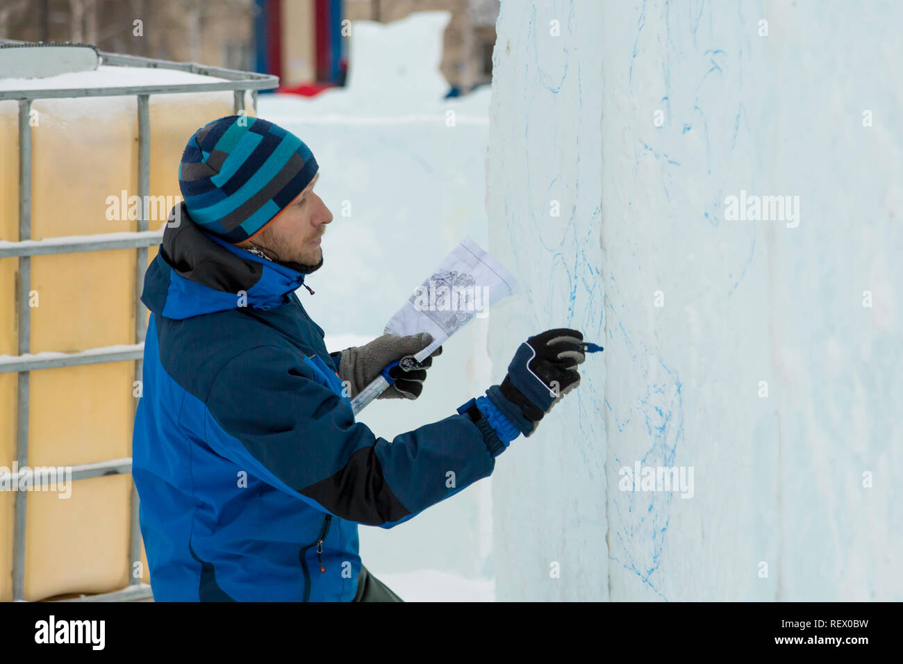 The artist draws the contours of the future ice figure on the ice Stock