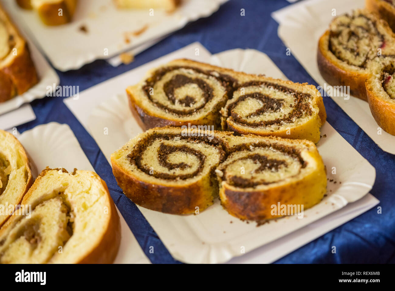 Shtrodel Delicious strudel piece with spiral inside on white cardboard plate on ...