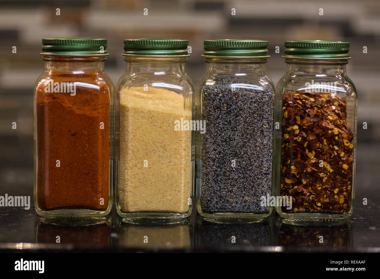 Jars of spices on a kitchen counter Stock Photo